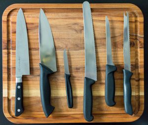 Knives on a wooden cutting board.