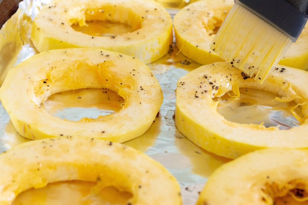 spaghetti squash sliced into ring with olive oil brushed on
